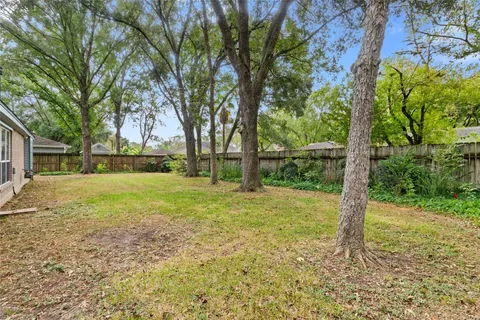 a house that has a tree in front of it