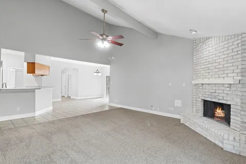 a view of empty room with a fireplace