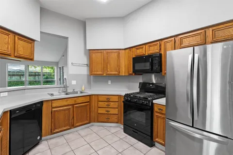 a kitchen with a refrigerator sink and microwave