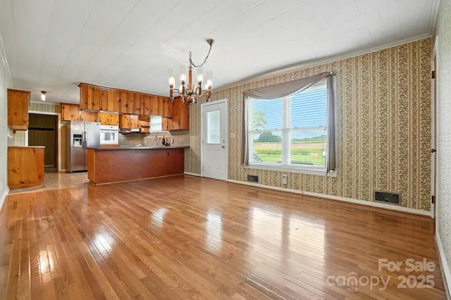 a large room with wooden floor and windows