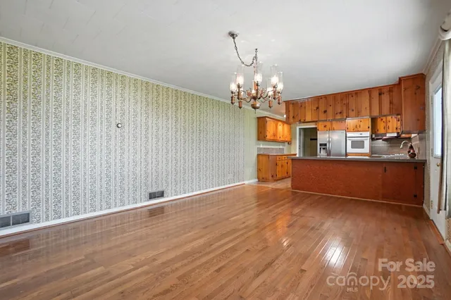 a view of a kitchen with cabinets and wooden floor