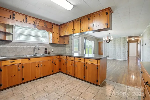 a large kitchen with stainless steel appliances granite countertop a sink and cabinets