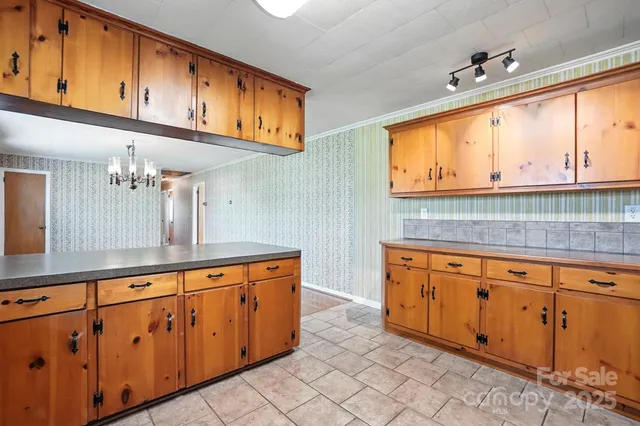 a kitchen with stainless steel appliances granite countertop a sink and cabinets