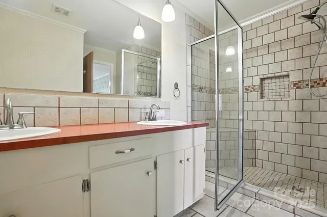 an empty room with windows and fan view