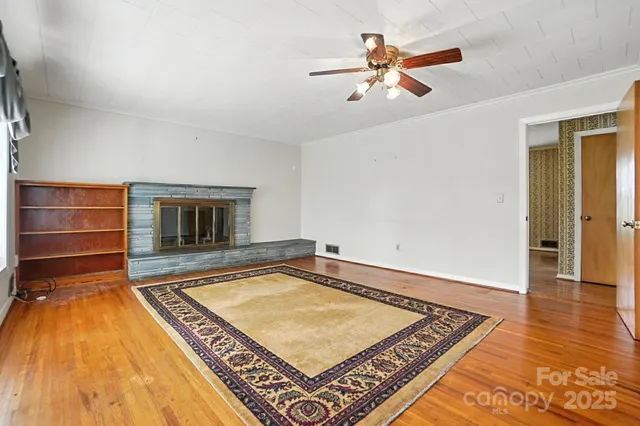a living room with pool table and a rug