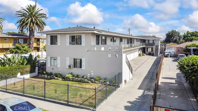 front view of house with a yard and potted plants