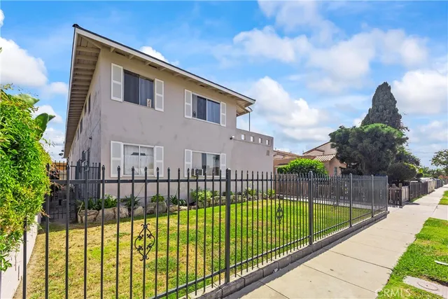 a view of a white building with a swimming pool