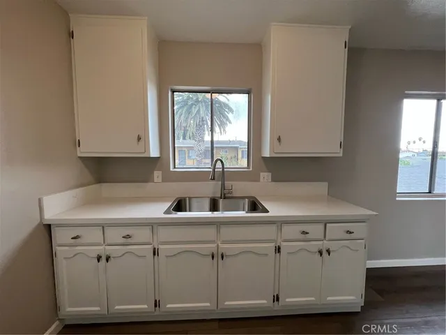a kitchen with white cabinets and a sink