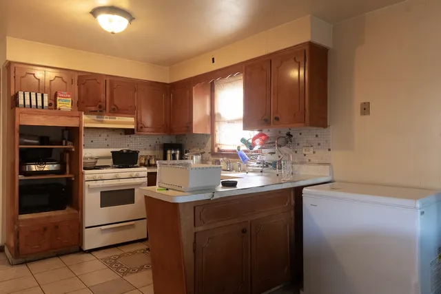 a kitchen with stainless steel appliances granite countertop a sink stove and cabinets