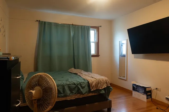 a bedroom with a bed and flat screen tv