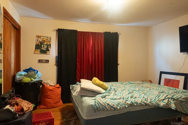 a bed sitting in a bedroom next to a window