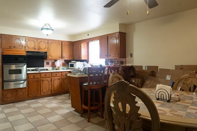 a kitchen with granite countertop a sink cabinets and stainless steel appliances