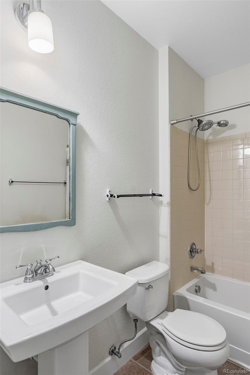 2908 Ironton Street Denver, CO 80238 - Photo 23 of 30 a bathroom with a sink a toilet and a mirror