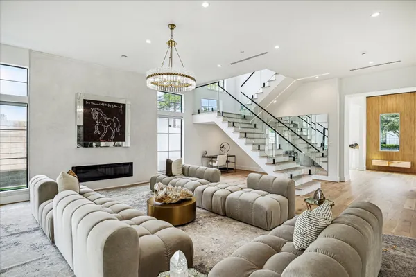 a kitchen with stainless steel appliances kitchen island granite countertop a sink a stove and a wooden floors