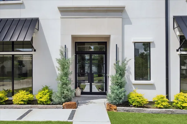 front view of a house with potted plants