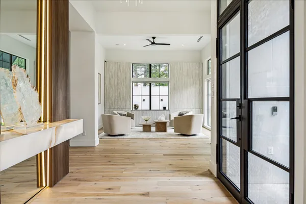 a dining room with furniture a window and wooden floor