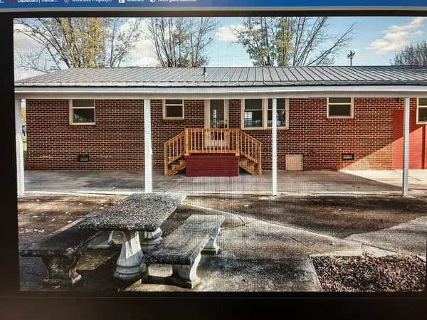 a bathroom with a bathtub and next to a window