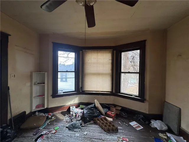 a room with furniture and two windows