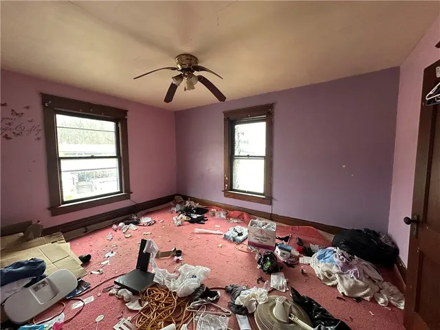 a bed sitting in a bedroom next to a window