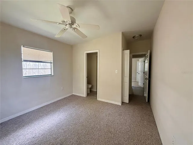 a bathroom with a granite countertop sink a toilet and bathtub
