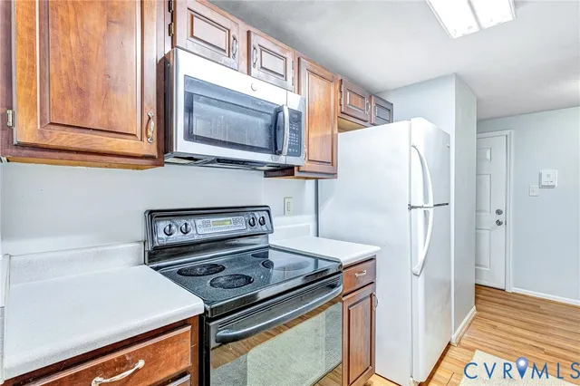 a kitchen with a refrigerator stove and microwave