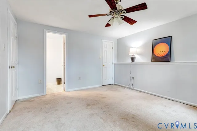 an empty room with window and fan