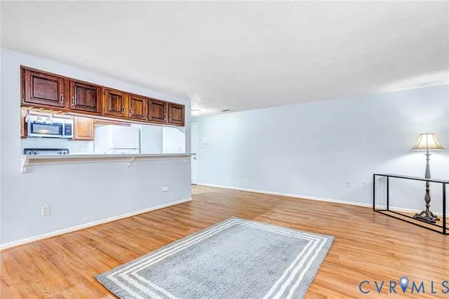 a view of a room with wooden floor