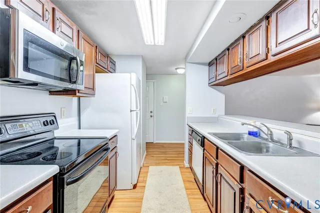 a kitchen with stainless steel appliances granite countertop a sink and a stove