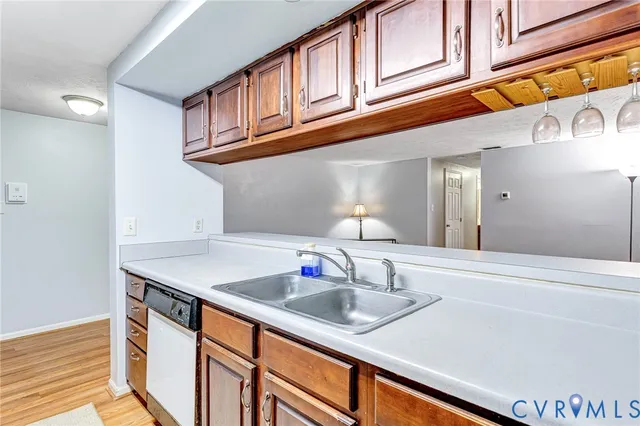 a kitchen with stainless steel appliances granite countertop a sink and cabinets
