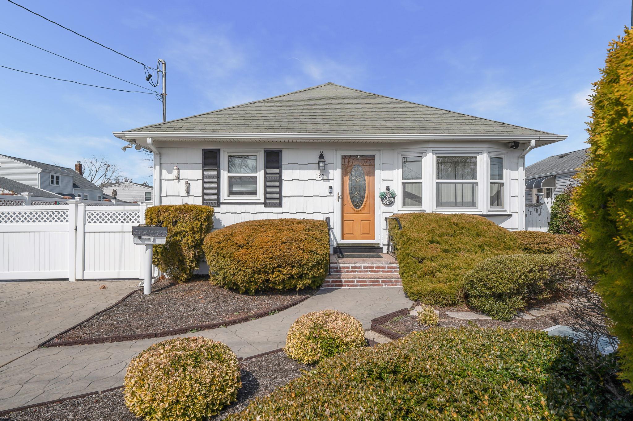 187 Islip Boulevard Islip Terrace, NY 11752 - Photo 1 of 1 Bungalow-style house featuring a shingled roof and fence
