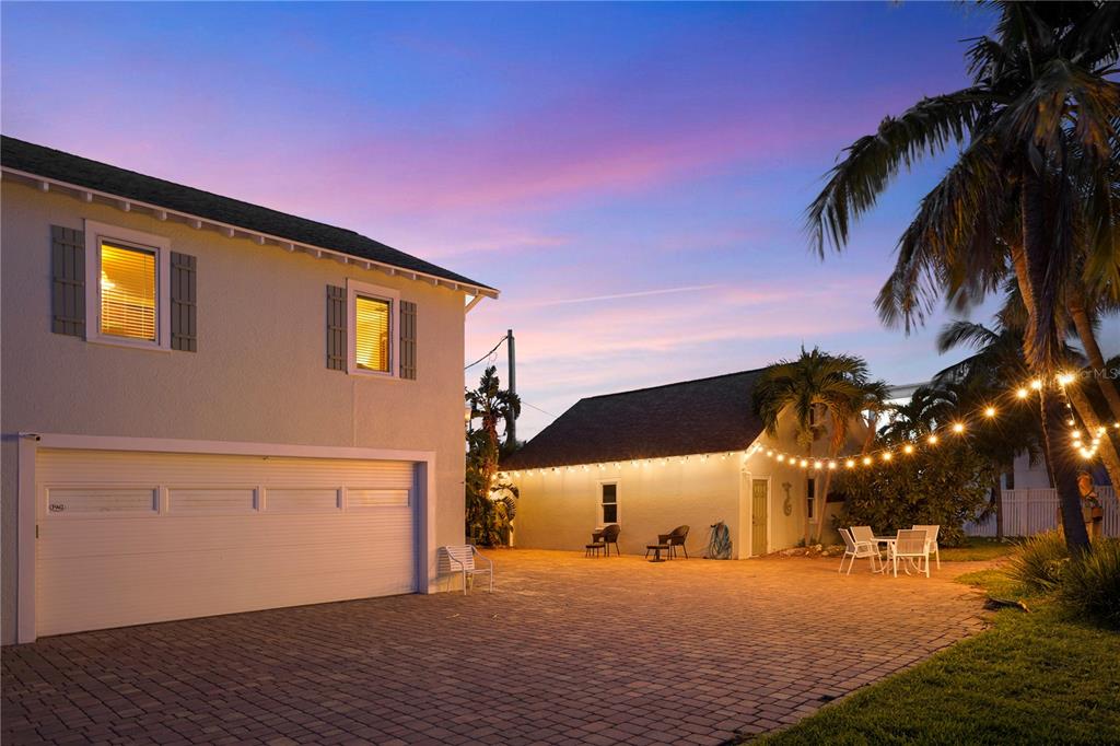 702 Pass A Grille Way St. Pete Beach, FL 33706 - Photo 36 of 41 a front view of a house with a yard and garage