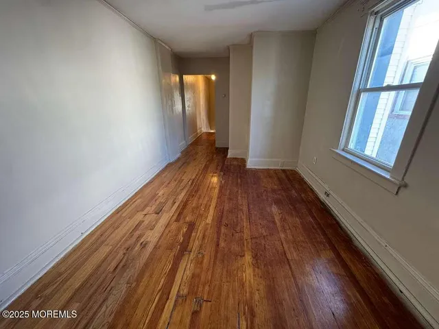 a view of a room with wooden floor and staircase