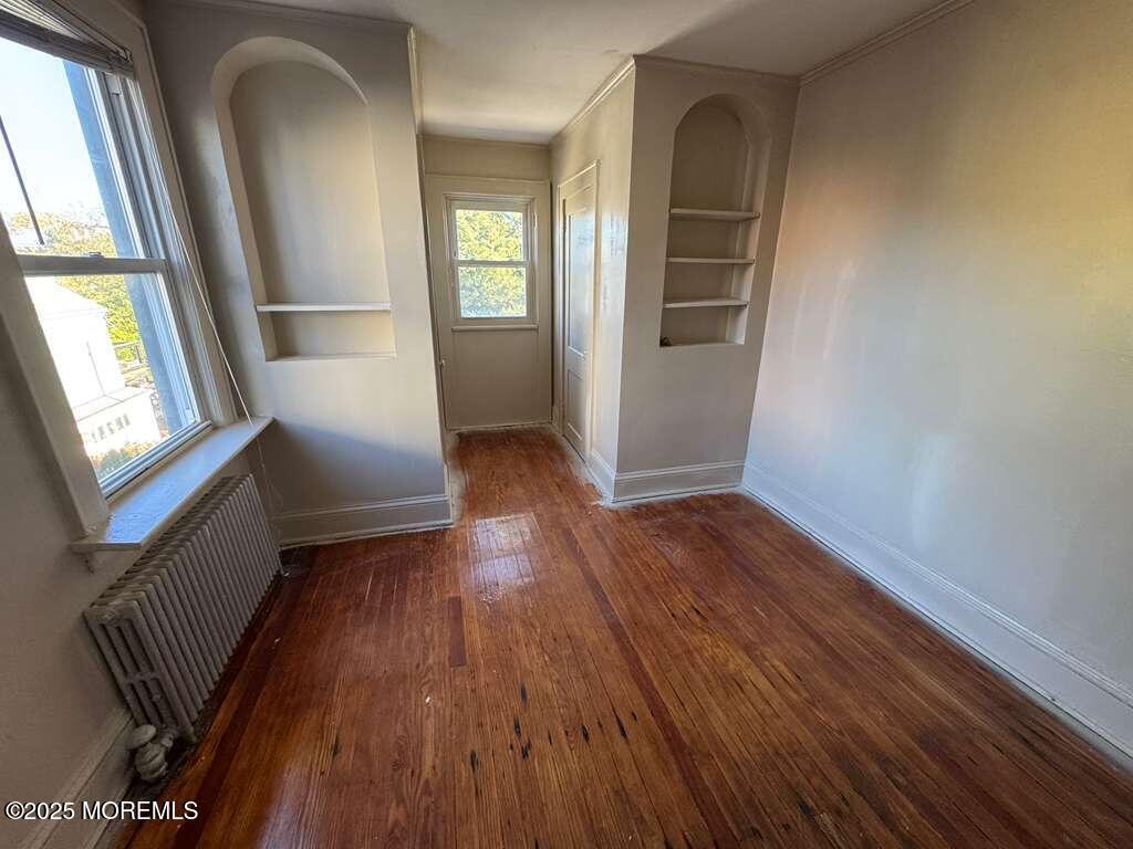 110 Rector Street, Unit 2 Perth Amboy, NJ 08861 - Photo 3 of 6 wooden floor in an empty room with a window