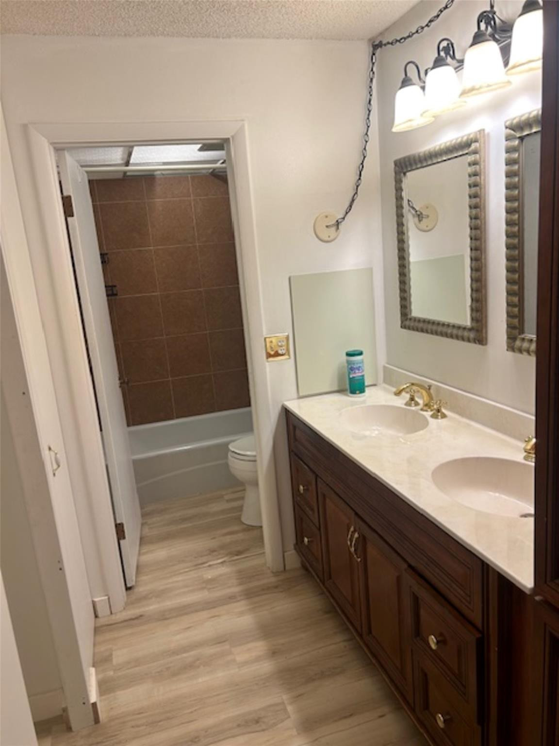 3720 Inverrary Drive, Unit 1T Lauderhill, FL 33319 - Photo 7 of 36 a bathroom with a double vanity sink and mirror