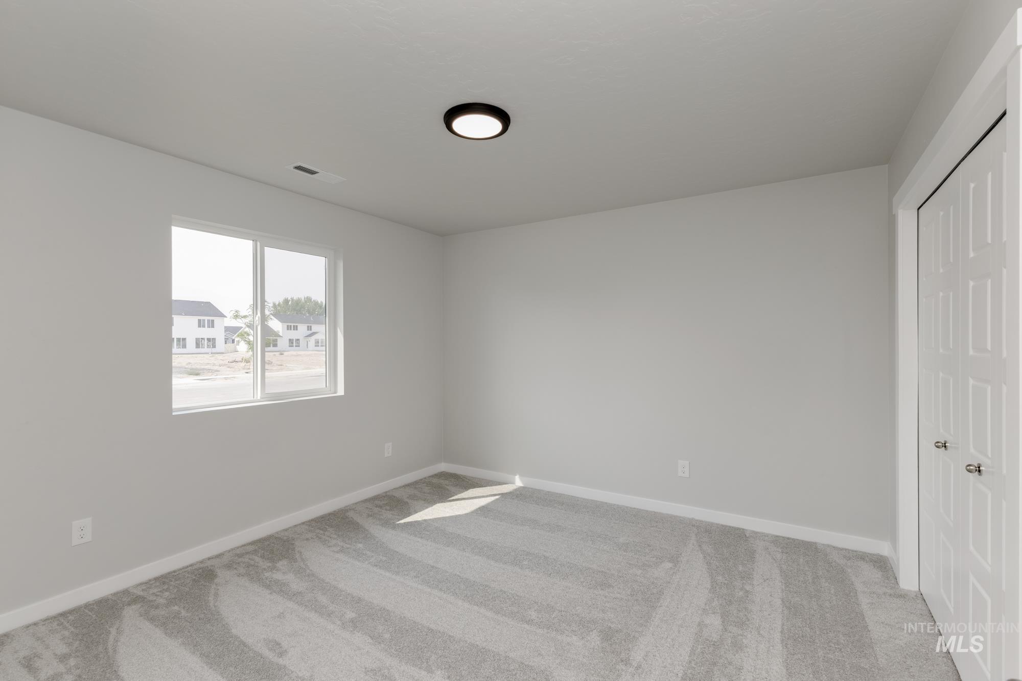 5315 Castleton Avenue Nampa, ID 83686 - Photo 12 of 19 Unfurnished bedroom with light carpet and a closet