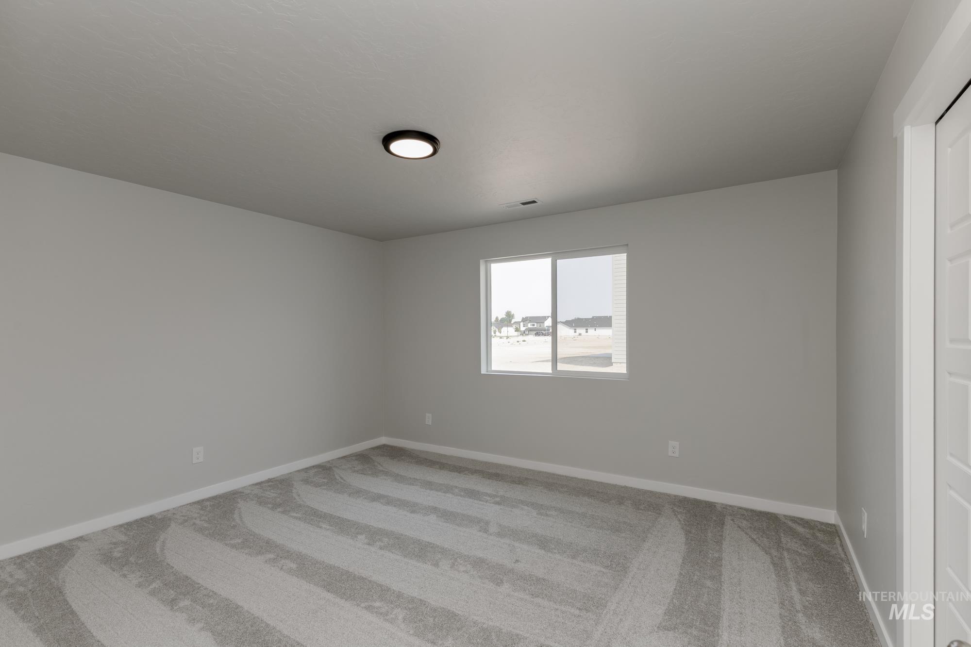 5315 Castleton Avenue Nampa, ID 83686 - Photo 14 of 19 Unfurnished room with light colored carpet and baseboards