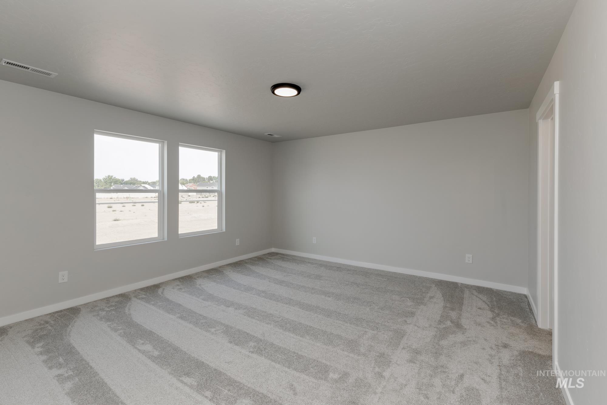 5315 Castleton Avenue Nampa, ID 83686 - Photo 16 of 19 Empty room featuring light colored carpet and baseboards