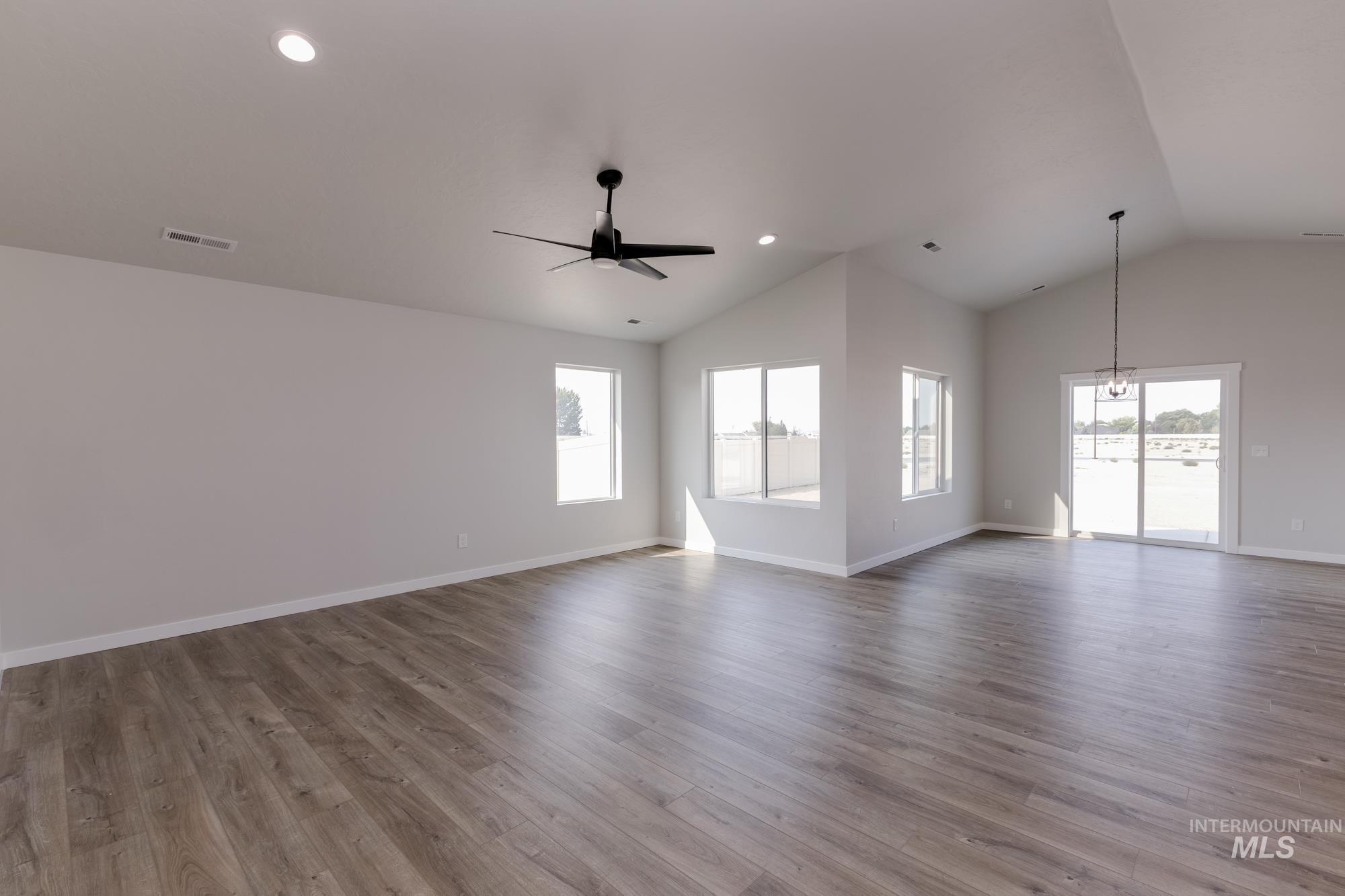 5315 Castleton Avenue Nampa, ID 83686 - Photo 8 of 19 Unfurnished living room featuring healthy amount of natural light, light wood finished floors, ceiling fan, recessed lighting, and high vaulted ceiling