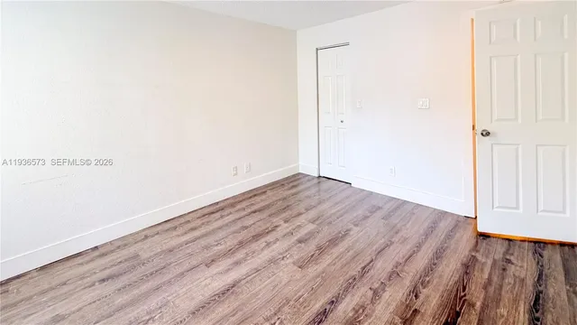 an empty room with wooden floor