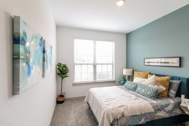 a bedroom with bed and a window