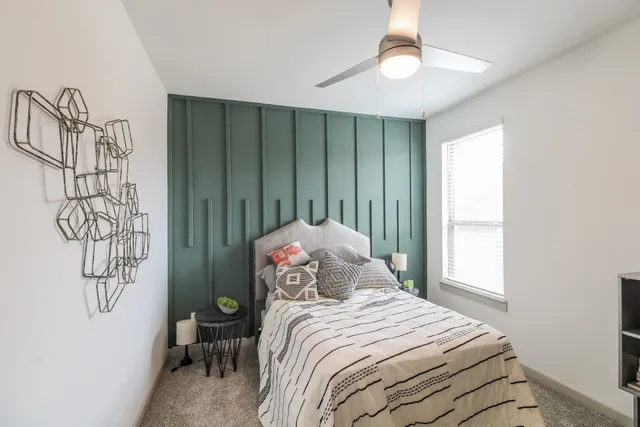 a bedroom with a bed and a chandelier