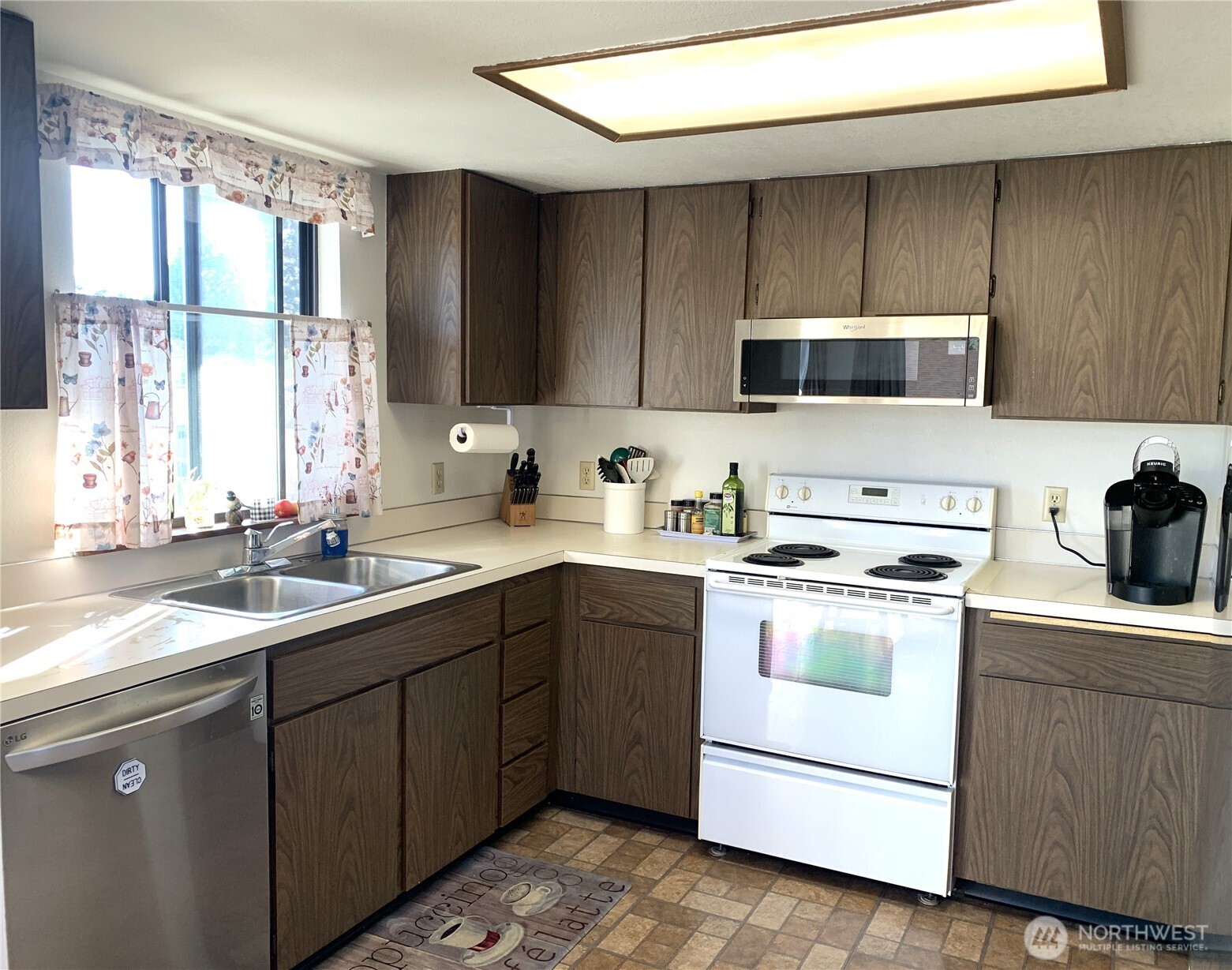416 Meade Avenue Sumner, WA 98390 - Photo 10 of 39 a kitchen with a sink stove top oven and cabinets
