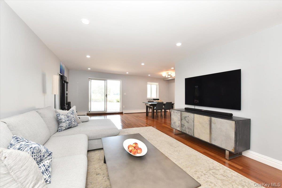320 East Shore Road, Unit 2A Great Neck, NY 11023 - Photo 8 of 28 a living room with furniture and a flat screen tv