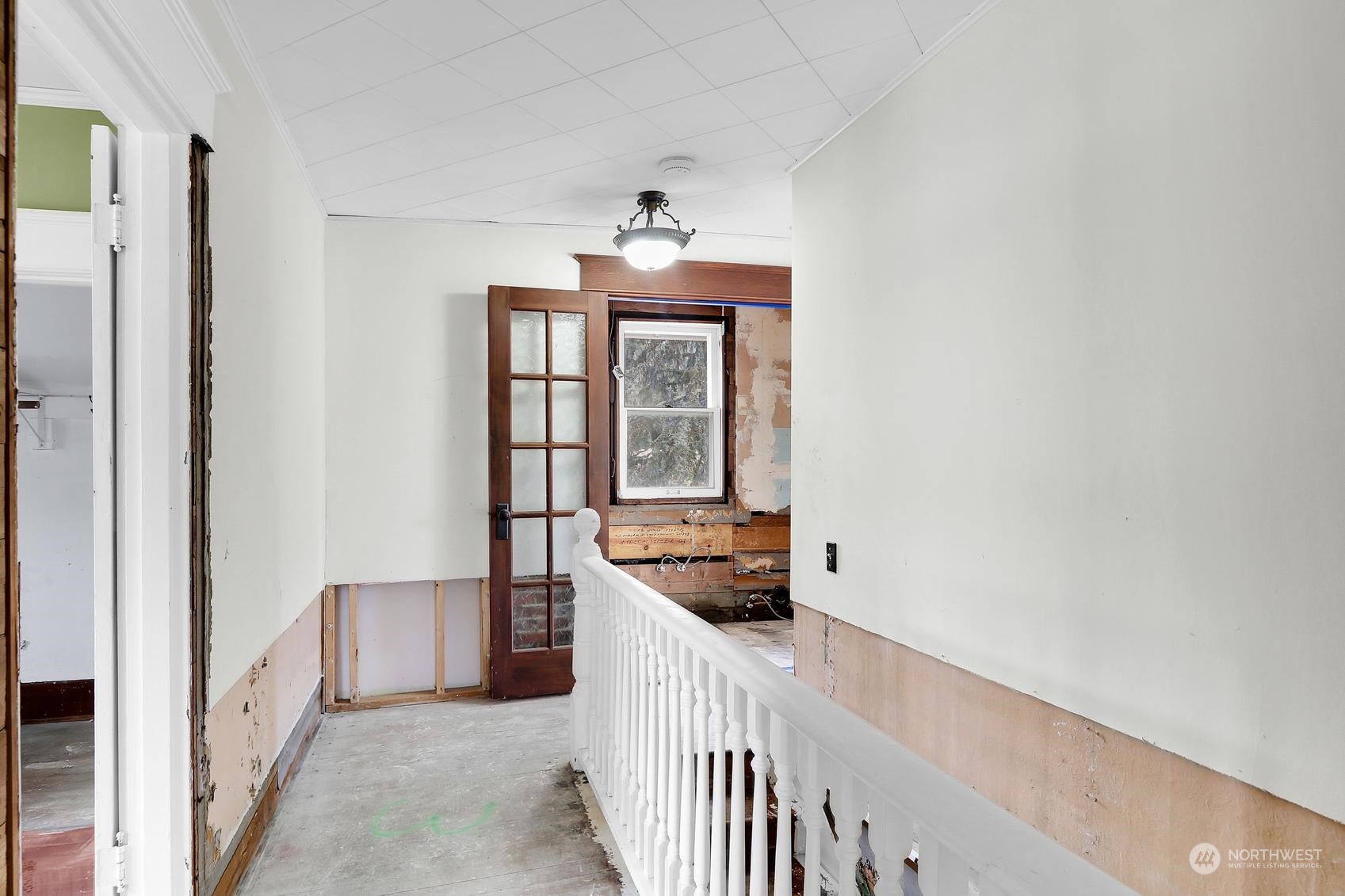 375 East Sunset Way Issaquah, WA 98027 - Photo 20 of 26 a view of a hallway with windows and chandelier