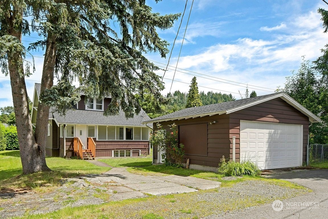375 East Sunset Way Issaquah, WA 98027 - Photo 3 of 26 a front view of a house with a yard