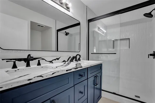 a bathroom with a double vanity sink and a mirror