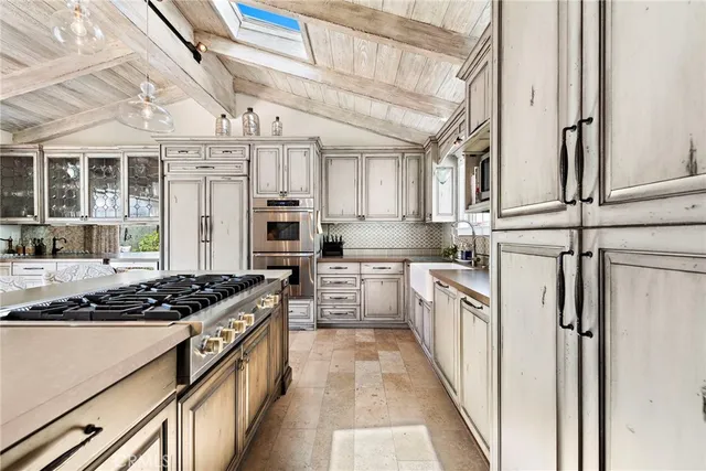 a kitchen with stainless steel appliances granite countertop a stove and a refrigerator