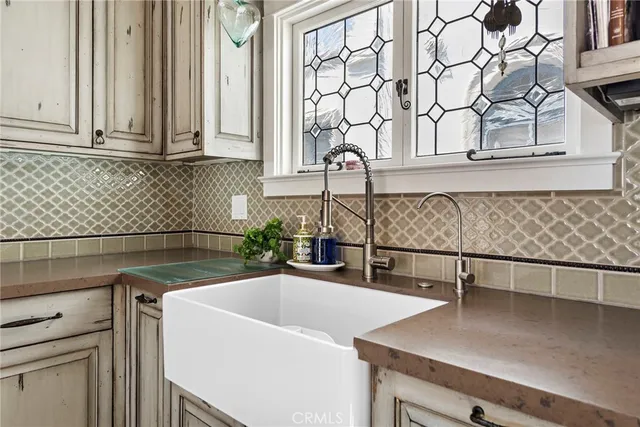 a kitchen with a sink and white cabinets