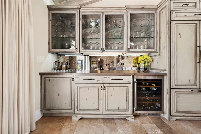 a kitchen with white cabinets and a window