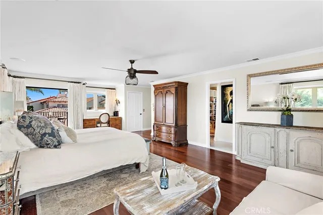 a bedroom with a large bed and a wooden floor